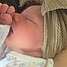 baby, chevron_pattern, child, closeup, cozy, cute, face, floral_pattern, headband, infant, mouth, newborn, onesie, peaceful, pillow, resting, skin, sleeping, soft_lighting, thumb