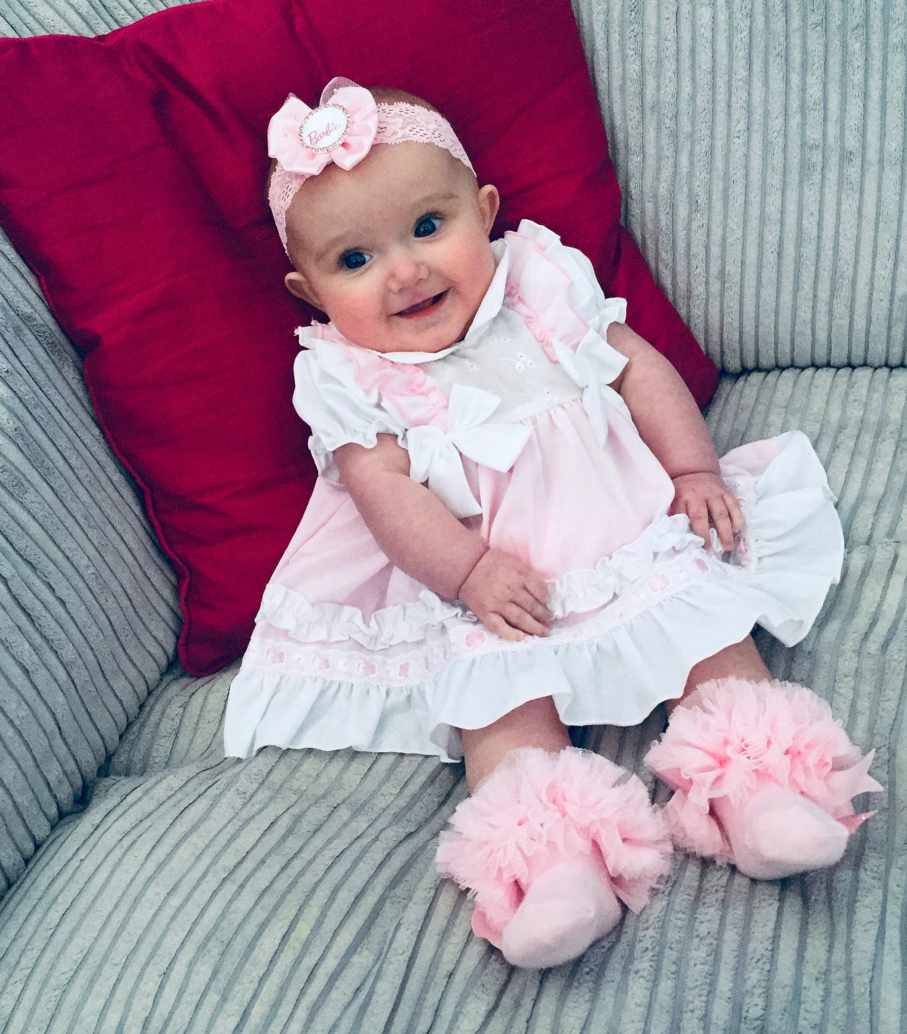 Stella-mae is registered to the contest to win money with this photo: baby, baby_toddler_clothing, comfort, couch, dress, eye, flash_photography, happy, head, headwear, magenta, person, petal, pink, purple, red, skin, sleeve, smile, textile