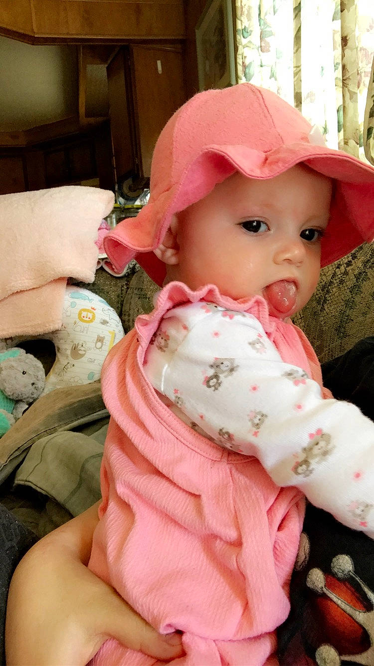 Daniela is registered to the contest to win money with this photo: baby, baby_products, bonnet, cheek, child, headgear, headwear, person, pink, toddler