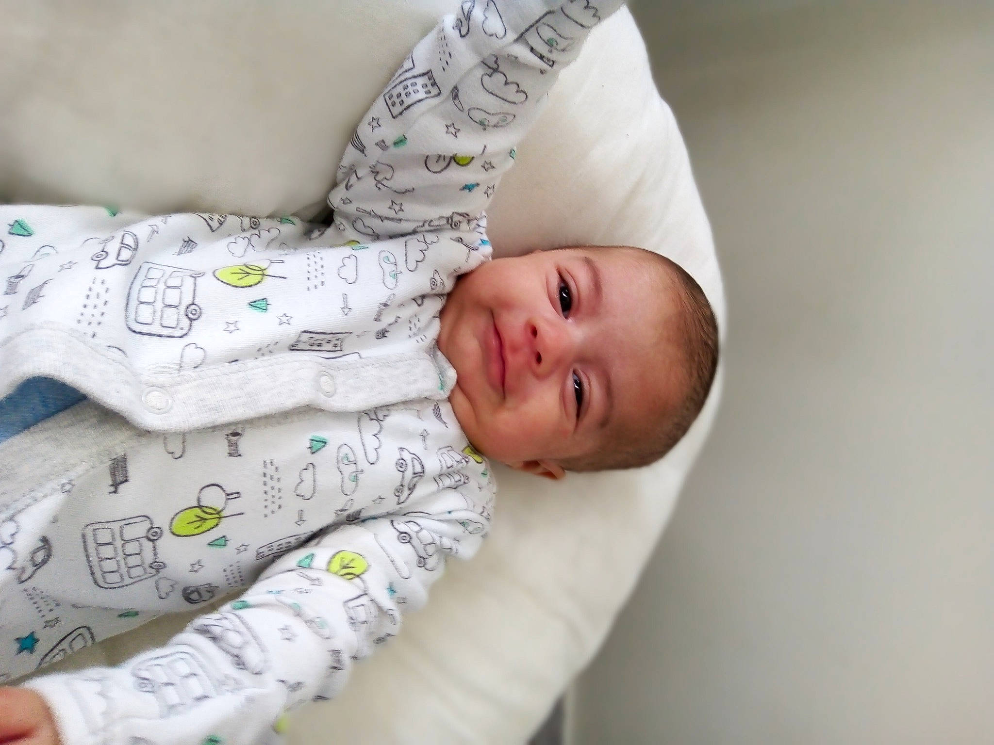 Archie is registered to the contest to win money with this photo: arm, baby, baby_products, baby_sleeping, baby_toddler_clothing, child, collar, comfort, facial_expression, hand, happy, head, human_body, linens, pattern, person, skin, sleeve, smile, t_shirt