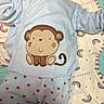 Zain joined the competition — help win amazing prizes! baby, blanket, child, clothing, cozy, cute, face, indoor, infant, lying_down, monkey, newborn, onesie, pattern, portrait, profile, rainbow, side_view, sleepwear, stars