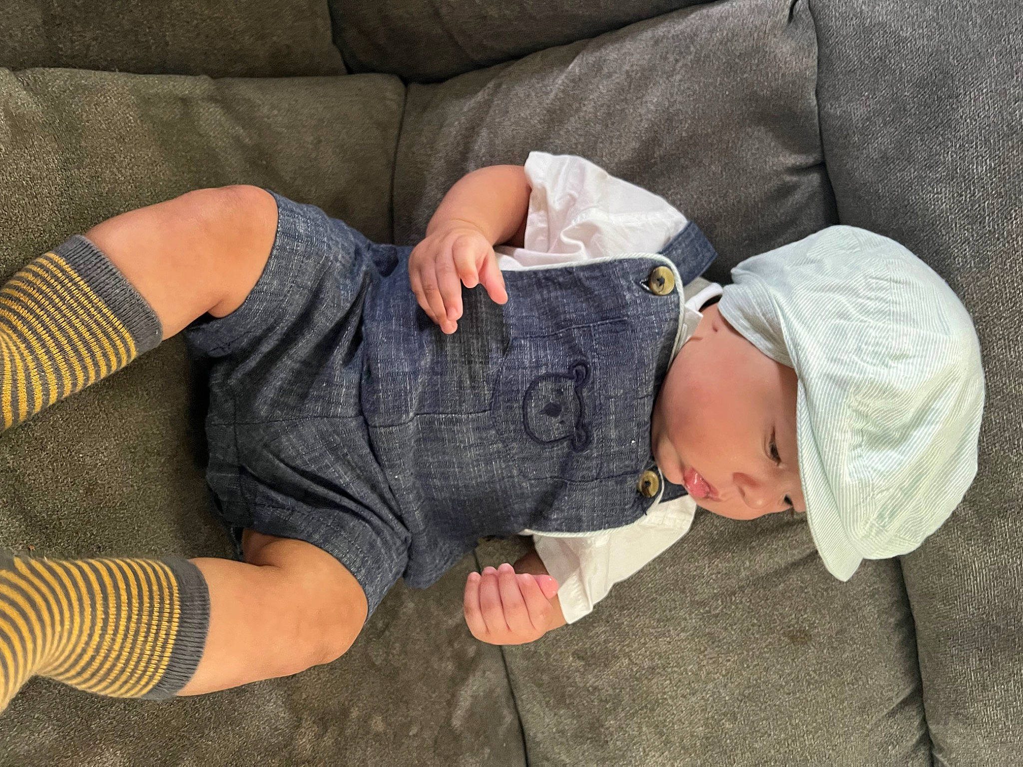 Jackson joined the competition — help win amazing prizes! arm, baby, baby_toddler_clothing, comfort, elbow, finger, gesture, glasses, grey, hand, headwear, human_body, joint, knee, lap, leg, person, skin, sleeve, t_shirt