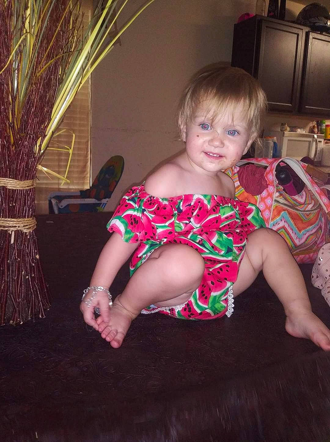 Queen is registered to the contest to win money with this photo: baby_toddler_clothing, beauty, cabinetry, dress, event, eye, flooring, fun, head, human_body, iris, kitchen_appliance, lap, leg, lighting, magenta, person, plant, sitting, smile