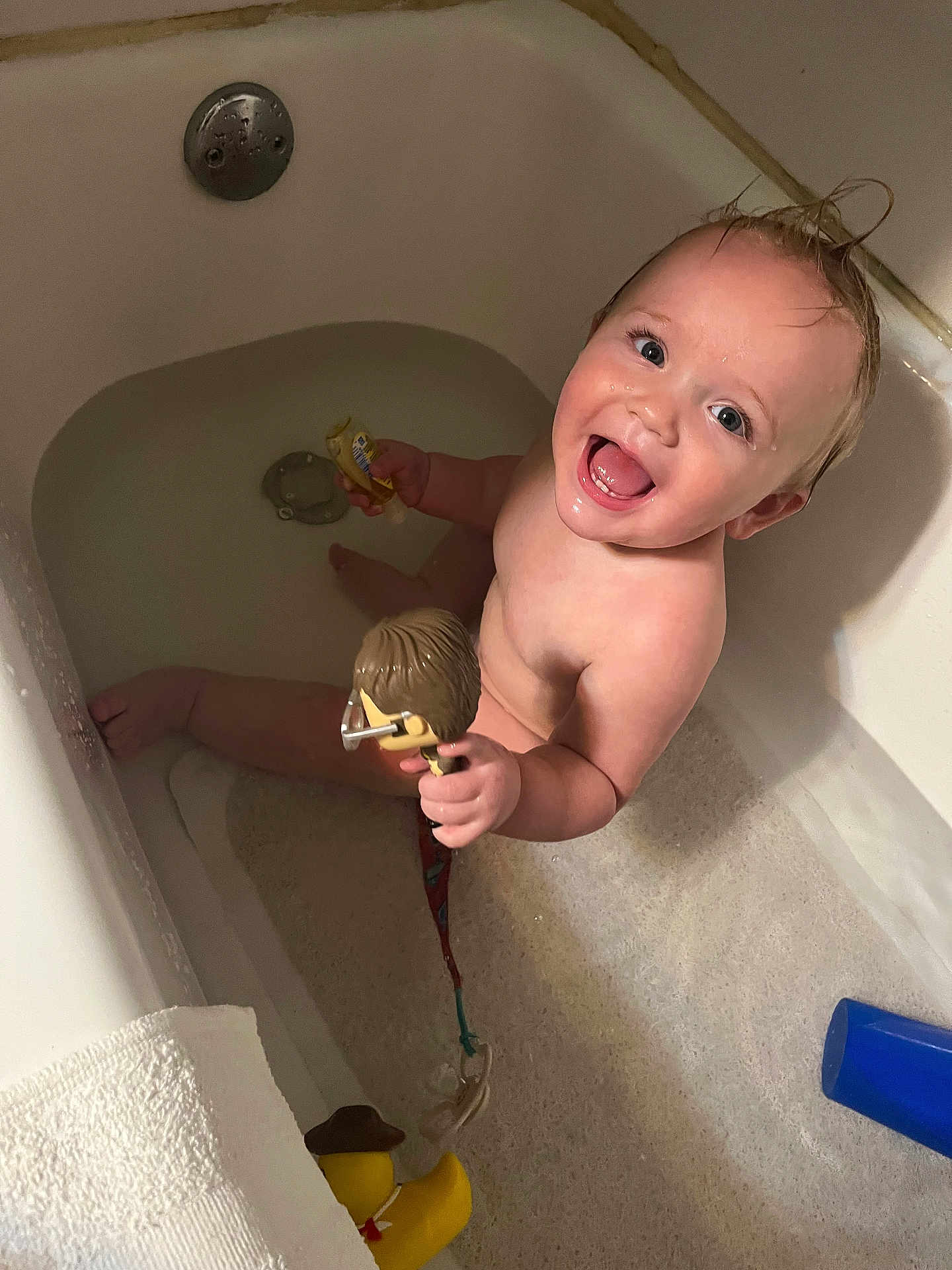 Noah joined the competition — help win amazing prizes! baby, bathtub, bath, toy, rubber_duck, child, smiling, happy, water, wet_hair, towel, plastic_toy, indoor, skin, person, fun, playful, cute, bath_time, face
