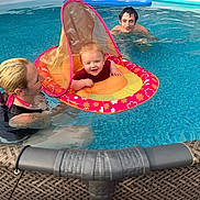 Noah joined the competition — help win amazing prizes! baby, inflatable_ring, pool, water, woman, man, smile, swimming, summer, outdoor, fun, child, family, floating, happy, recreation, blue, tattoo, adult, people