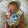 Cullen is registered to the contest to win money with this photo: baby, pacifier, infant, cushion, polka_dot, white_shirt, blue_text, hand, skin, fingers, clothing, cute, child, newborn, lying_down, indoor, human, portrait, small, comfort