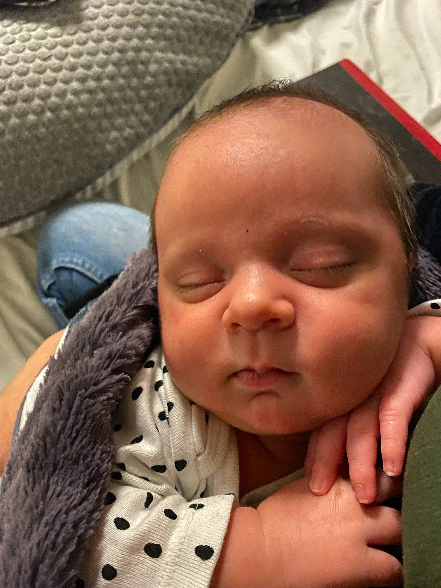 Lennon is registered to the contest to win money with this photo: baby, cheek, chin, comfort, eyebrow, eyelash, facial_expression, finger, gesture, happy, head, human, lip, mammal, mouth, nose, organ, person, skin, sleeve