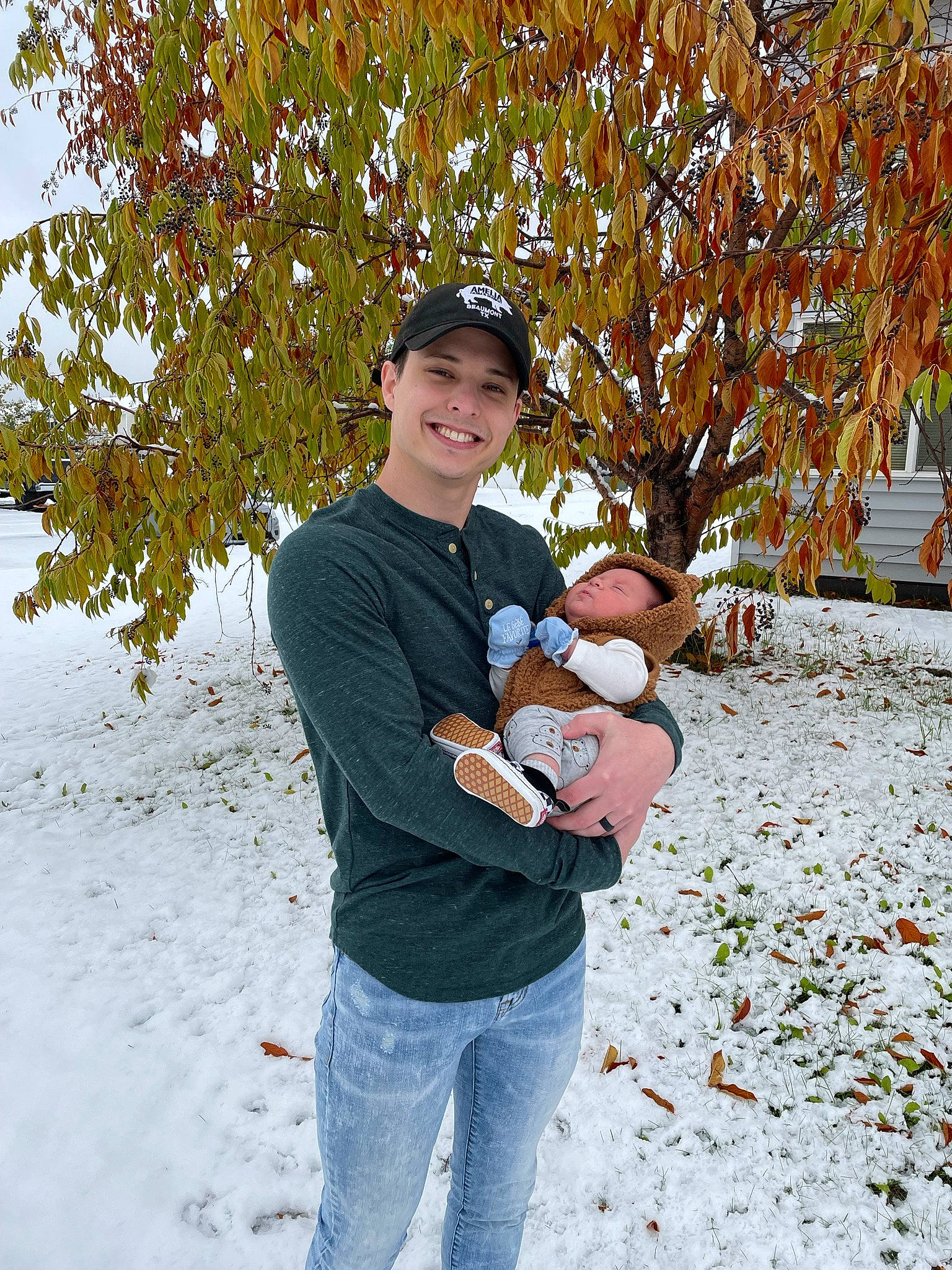Lennon is registered to the contest to win money with this photo: freezing, fruit, fun, grass, happy, hat, headwear, human_body, jeans, joy, leaf, leisure, people_in_nature, person, plant, sitting, smile, t_shirt, toy, tree