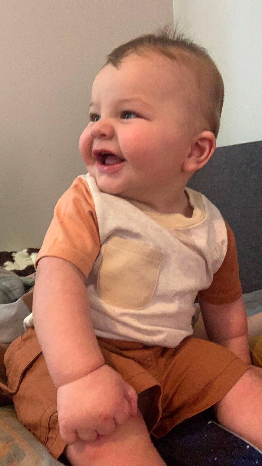 Trace is registered to the contest to win money with this photo: arm, baby, baby_toddler_clothing, cheek, comfort, finger, hand, happy, head, joint, lip, mouth, neck, nose, person, skin, sleeve, smile, stomach, thumb