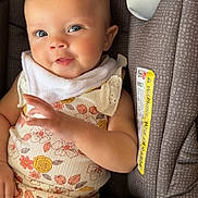 Lakelynn joined the competition — help win amazing prizes! baby, car_seat, child, closeup, clothing, comfort, cute, face, floral_pattern, hand, happy, head, indoors, infant, person, portrait, sitting, smiling, white_bib, young_child