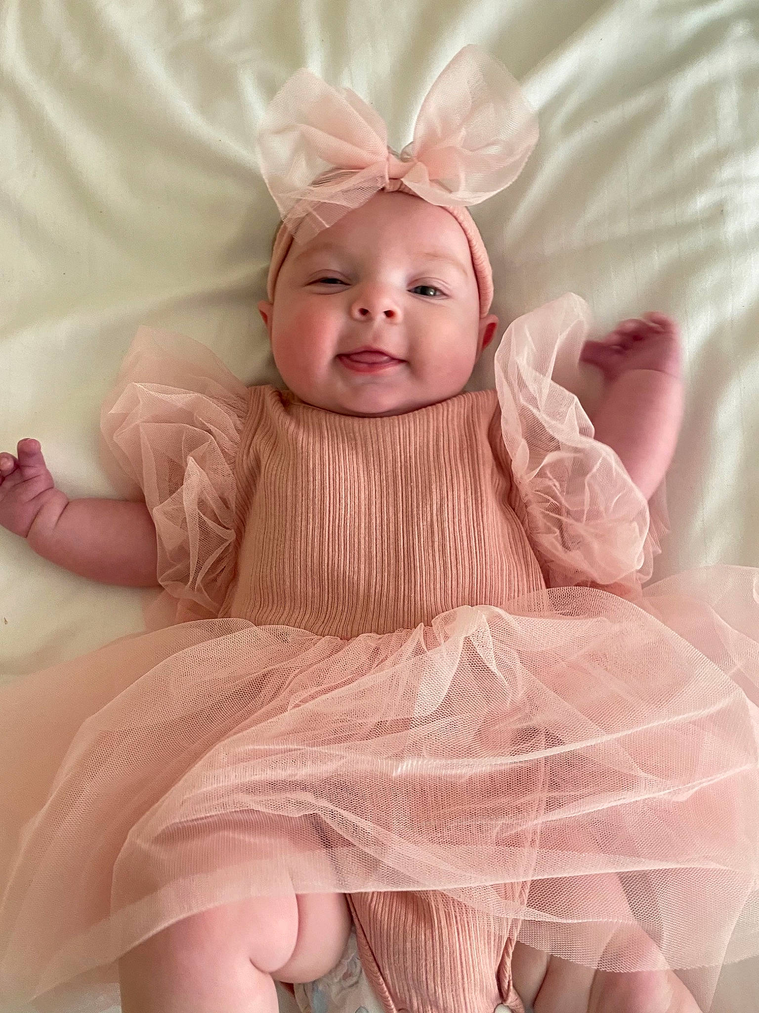 Hadley is registered to the contest to win money with this photo: baby, baby_toddler_clothing, comfort, embellishment, fashion_accessory, flash_photography, happy, headwear, lip, magenta, pattern, peach, person, pink, product, sitting, skin, sleeve, smile, textile