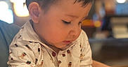 Daniyal is registered to the contest to win money with this photo: background_blur, boy, casual_clothing, child, closeup, curious, cute, engaged, expression, face, hands, indoor, indoor_lighting, person, portrait, shirt, short_hair, toddler, warm_lighting, young_child
