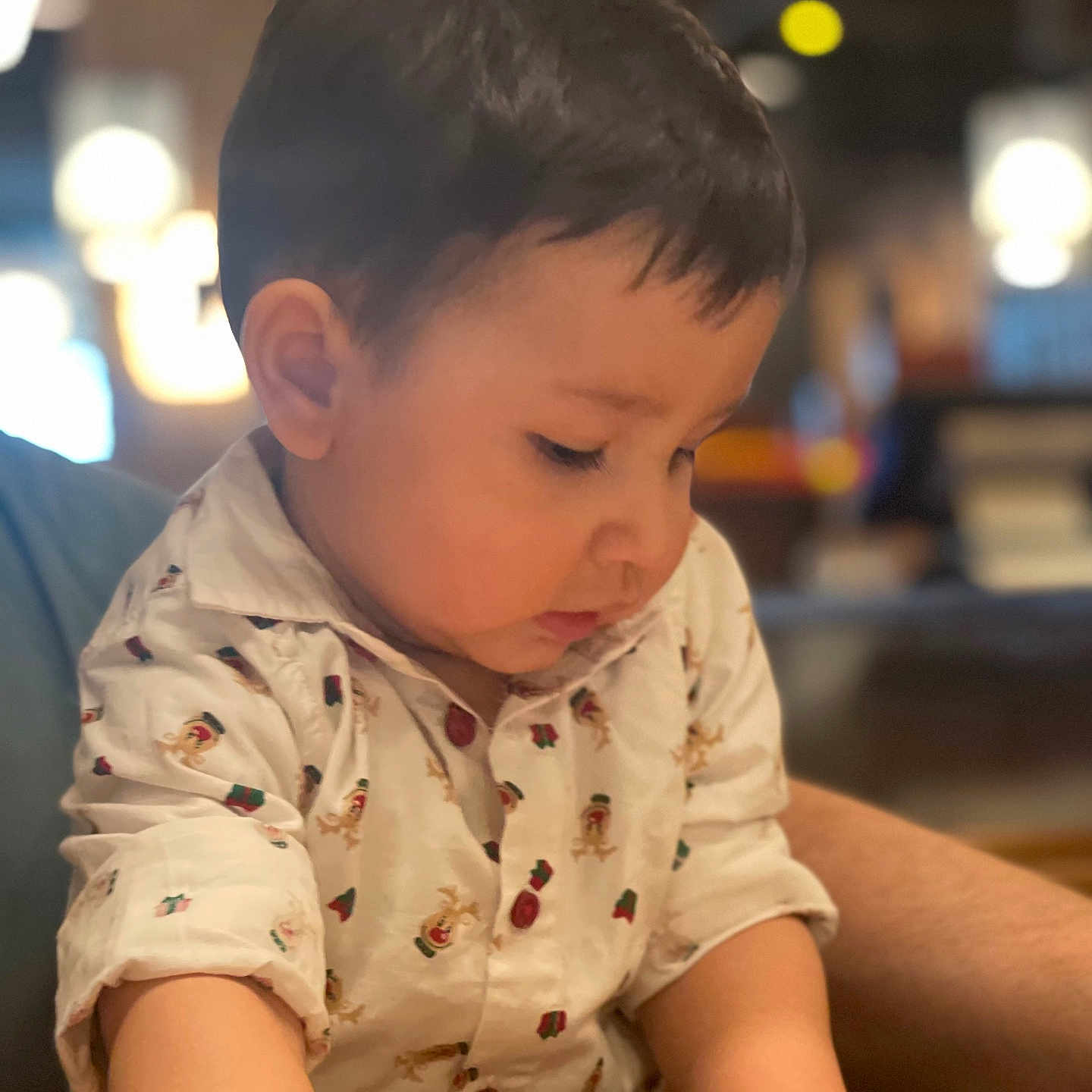 Daniyal is registered to the contest to win money with this photo: child, toddler, boy, shirt, indoor, portrait, face, hands, short_hair, cute, engaged, warm_lighting, background_blur, casual_clothing, person, closeup, expression, young_child, curious, indoor_lighting