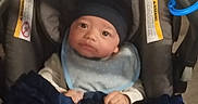 Destin is registered to the contest to win money with this photo: baby, bib, blanket, bottle, car_seat, child, clothing, comfort, cute, feeding, hat, indoor, infant, milk, newborn, person, resting, seat, soft, warm