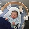 baby, baby_boy, baby_seat, blanket, blue_clothing, child, comfort, cushion, face, hand, head, indoor, infant, nap_time, newborn, pacifier, person, plush_toy, smile, toy