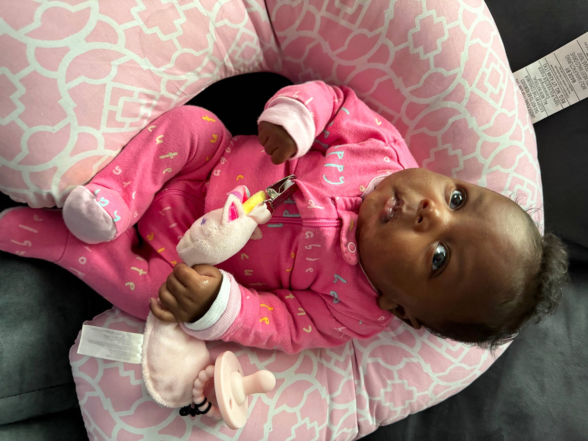 Paighton is registered to the contest to win money with this photo: baby, baby_products, baby_sleeping, bedtime, carmine, child, comfort, couch, happy, head, human_leg, linens, magenta, mouth, person, pillow, pink, room, skin, thigh