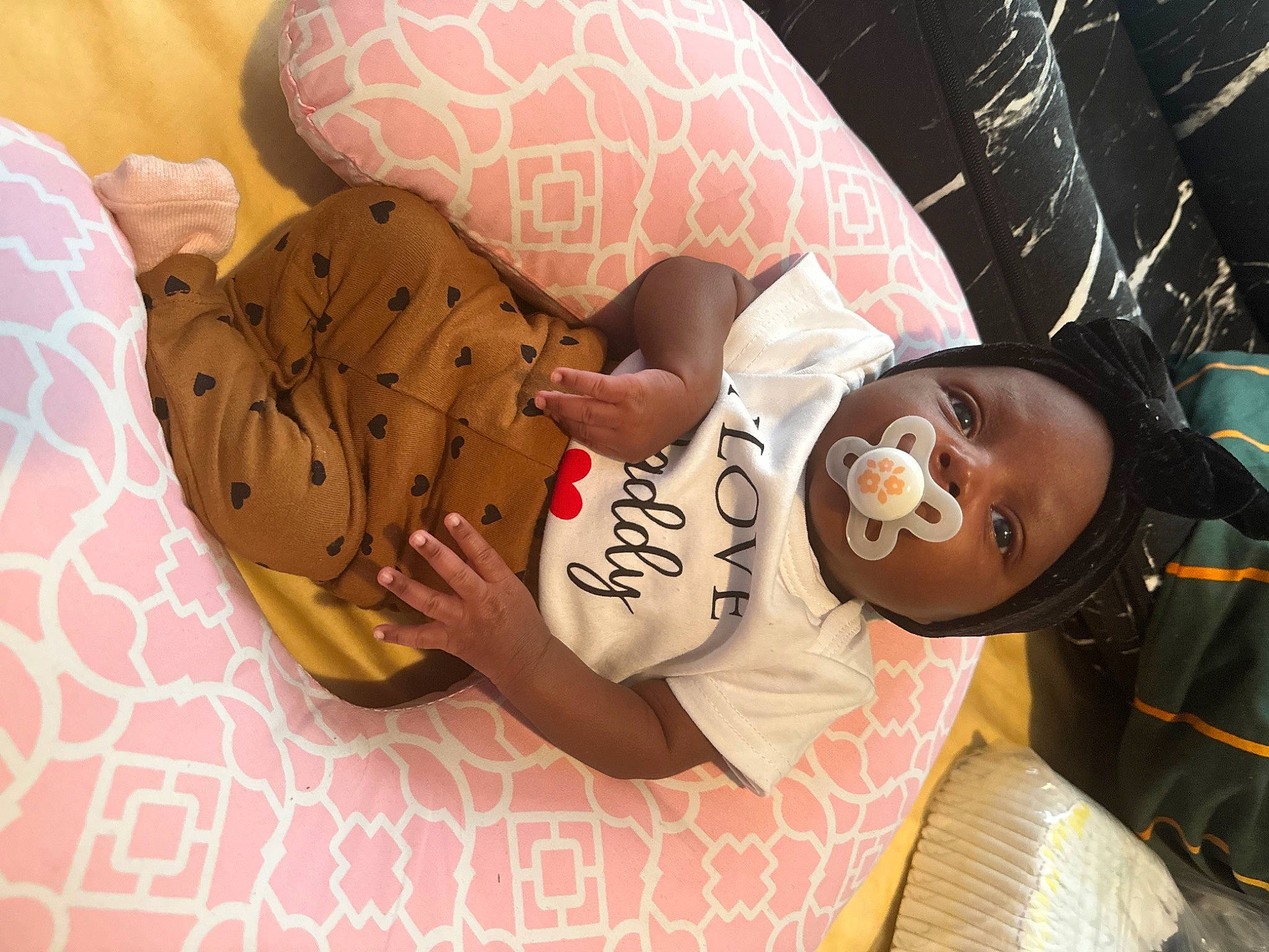 Paighton is registered to the contest to win money with this photo: abdomen, arm, baby, baby_products, baby_sleeping, baby_toddler_clothing, child, comfort, eyewear, hand, happy, hat, human_leg, linens, nail, pattern, person, room, sunglasses, thigh