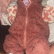 Evelyn joined the competition — help win amazing prizes! baby, sleeping, pink_clothing, pacifier, onesie, hood, slippers, bunny_slippers, soft_fabric, person, lap, infant, cute, resting, child, indoor, warm_clothing, cozy, blanket, sleep