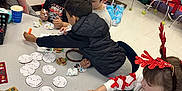 Taylin is registered to the contest to win money with this photo: child, children, classroom, crafts, holiday, reindeer_antlers, table, markers, stickers, decorations, kids, education, activity, sitting, indoor, festive, whiteboard, papers, seated, colorful