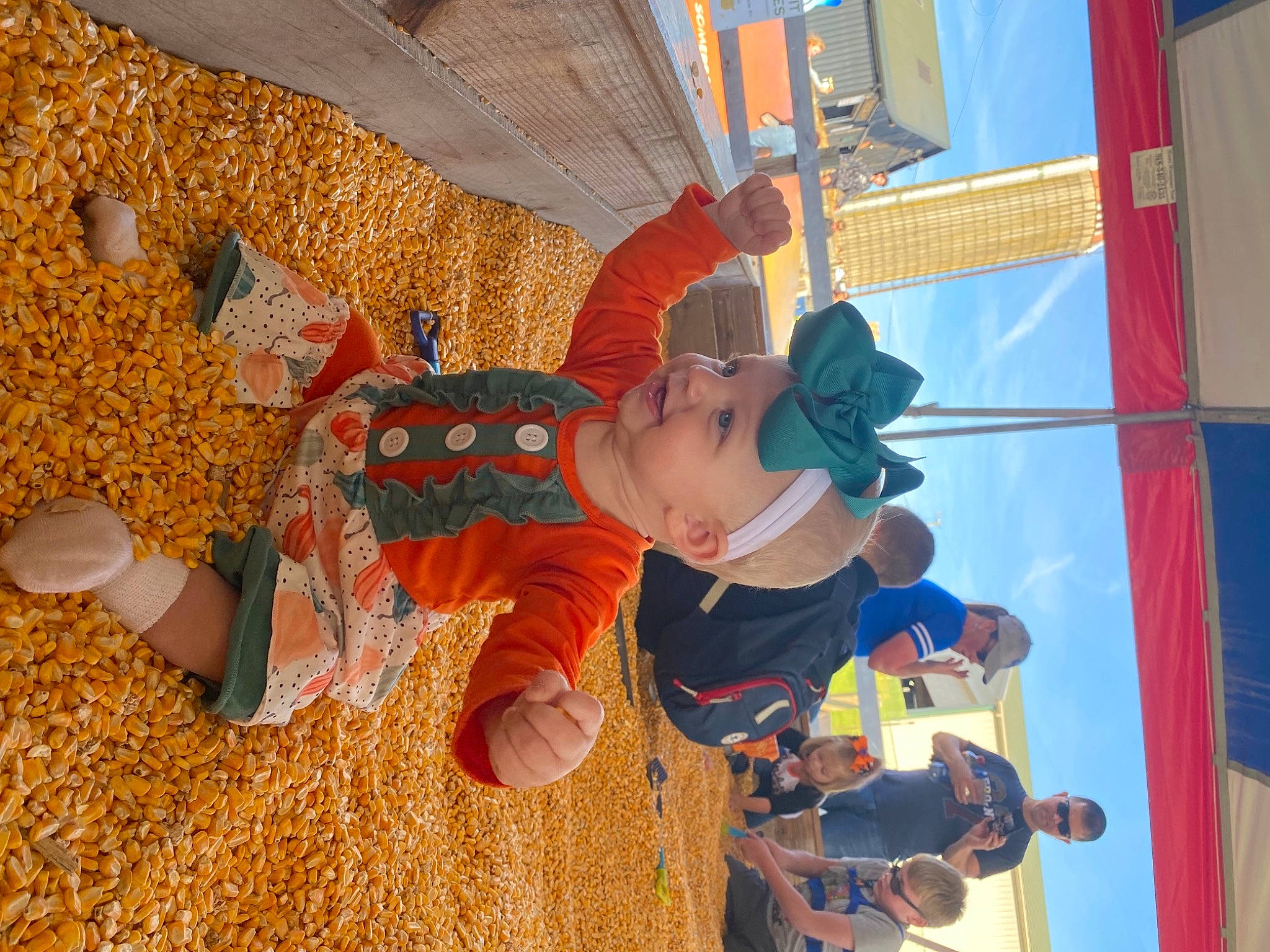 Emory is registered to the contest to win money with this photo: agriculture, baby, blurred, child, flooring, fun, happy, hat, headwear, leisure, orange, pattern, people_in_nature, person, play, pumpkin, recreation, room, toddler, world