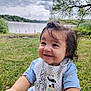 toddler, child, smiling, grass, lake, cloudy_sky, bib, giraffe, panda, outdoor, nature, greenery, happy, portrait, baby_clothes, cute, young_child, daylight, trees, water
