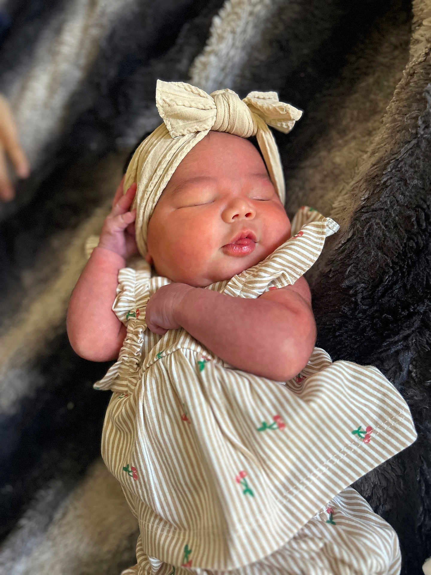 Kimberley joined the competition — help win amazing prizes! baby, sleeping, infant, headband, dress, striped_clothing, cherry_pattern, fuzzy_blanket, cute, peaceful, newborn, soft_texture, adorable, child, portrait, resting, indoor, skin, hand, face