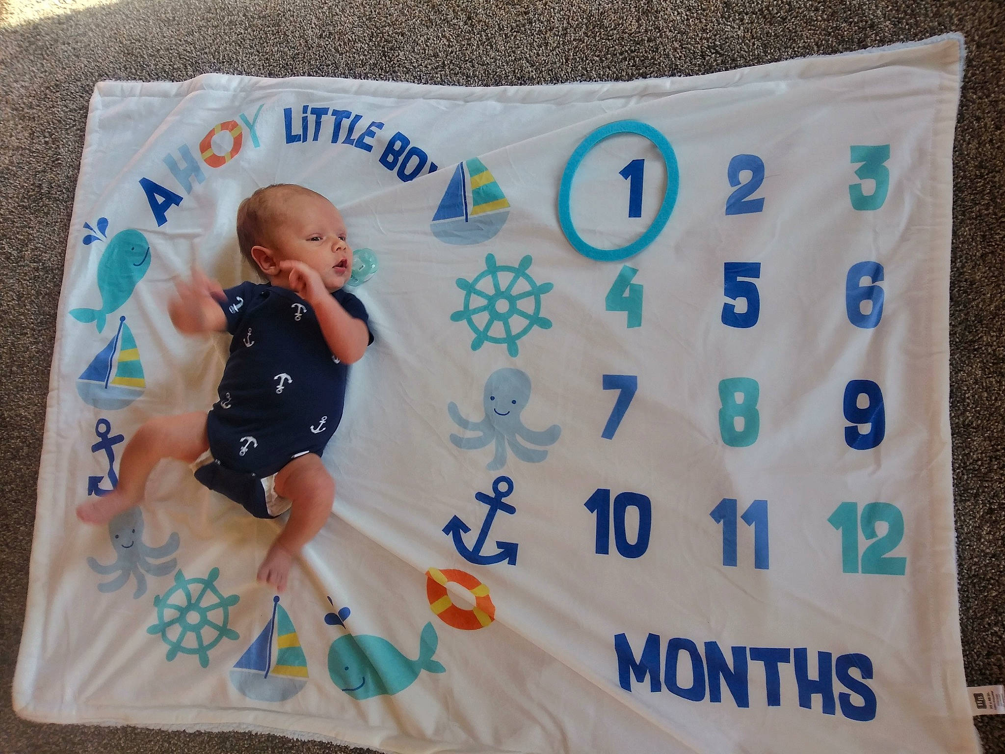 Bryce is registered to the contest to win money with this photo: azure, baby, baby_products, baby_toddler_clothing, child, event, font, fun, happy, infant_bodysuit, linens, pattern, person, product, rectangle, room, sleeve, t_shirt, textile, toddler