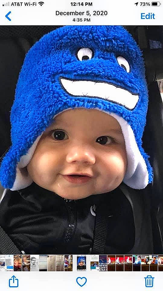 Alden is registered to the contest to win money with this photo: baby, blue, cap, cheek, chin, clothing, eyebrow, face, facial_expression, happy, headgear, headwear, human_body, mouth, nose, outerwear, person, photograph, product, purple