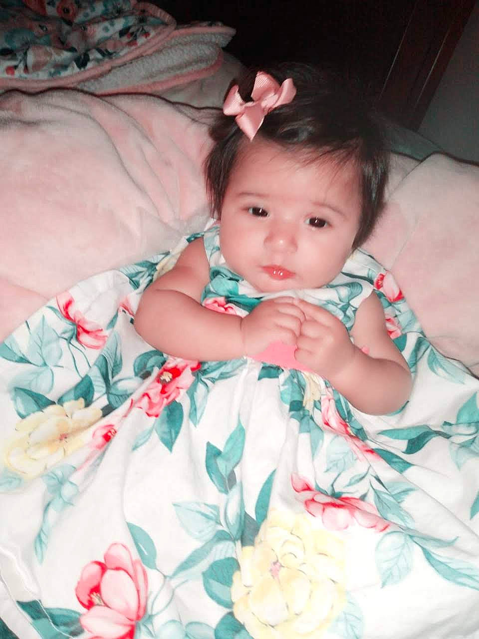 Grace joined the competition — help win amazing prizes! baby, baby_toddler_clothing, cheek, child, comfort, eye, face, finger, flash_photography, happy, head, iris, linens, lip, pattern, person, pink, sitting, skin, sleeve