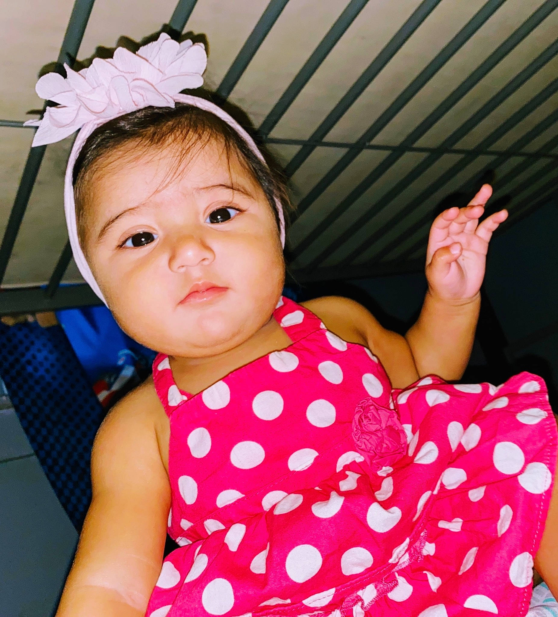 Grace is registered to the contest to win money with this photo: arm, baby_toddler_clothing, cheek, chin, eyelash, facial_expression, finger, gesture, hair, hairstyle, happy, human_body, lip, neck, organ, person, pink, shoulder, skin, sleeve