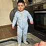 Adnan a rejoint le concours — aidez-le/la à gagner de superbes lots ! child, toddler, onesie, socks, standing, kitchen, oven, refrigerator, rug, wooden_spoon, countertop, utensils, flooring, fridge_magnets, indoor, portrait, cute, candid, messy, person