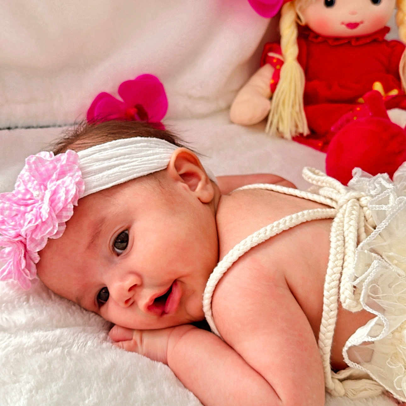 Helena is registered to the contest to win money with this photo: accessories, baby, bed, bodypart, bonnet, clothing, couch, doll, face, finger, furniture, hand, hat, head, headband, newborn, person, photography, portrait, toy