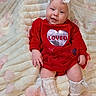 Julia joined the competition — help win amazing prizes! baby, infant, red_clothing, headband, bow, smile, blanket, pink_petals, white_socks, knitted_socks, ribbons, soft_texture, lying_down, cute, happy, portrait, child, toddler, indoors, celebration