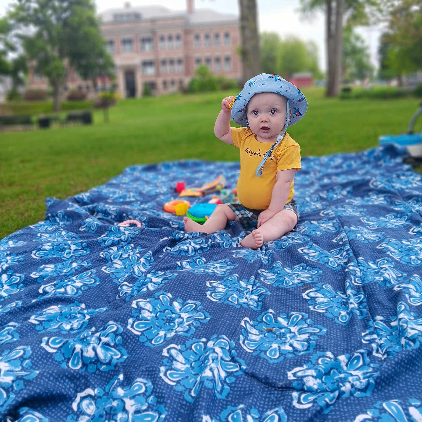 Manny is registered to the contest to win money with this photo: architecture, backyard, building, clothing, face, grass, hat, head, nature, outdoors, park, person, photography, plant, portrait, quilt, summer, tree, vegetation, yard