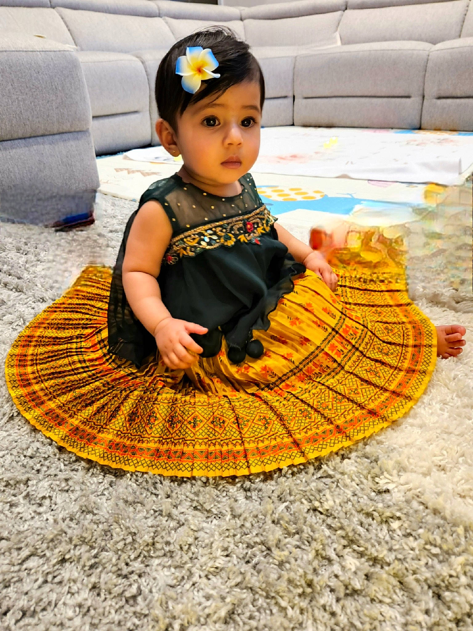 Dhiya is registered to the contest to win money with this photo: baby, baby_toddler_clothing, basket, carpet, child, couch, dress, fashion_accessory, floor, flooring, headgear, orange, pattern, person, photograph, sitting, textile, toddler, toy, white