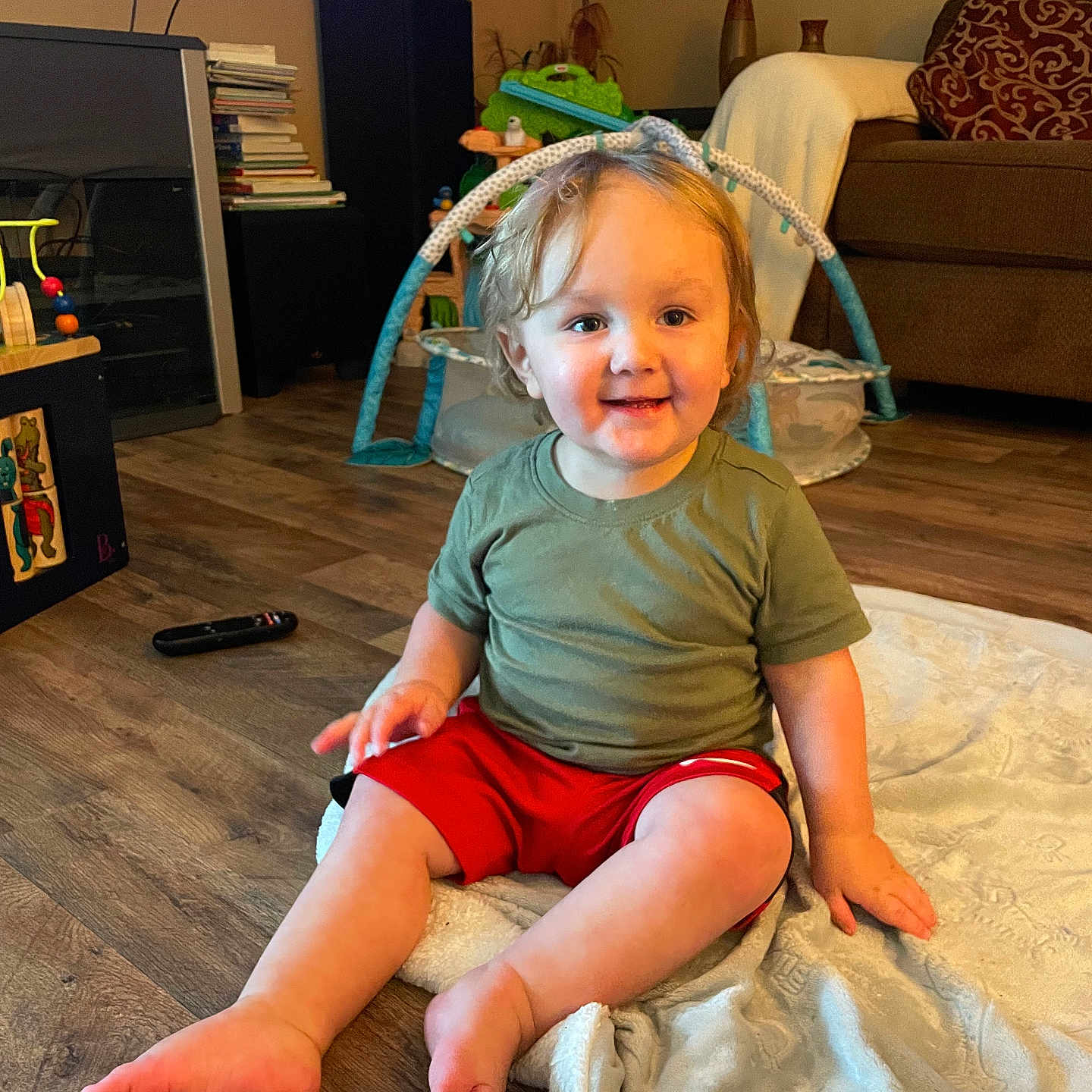 Liam is registered to the contest to win money with this photo: architecture, baby, building, clothing, couch, cushion, face, furniture, hardwood, head, homedecor, indoors, interiordesign, livingroom, person, photography, portrait, room, shorts, wood