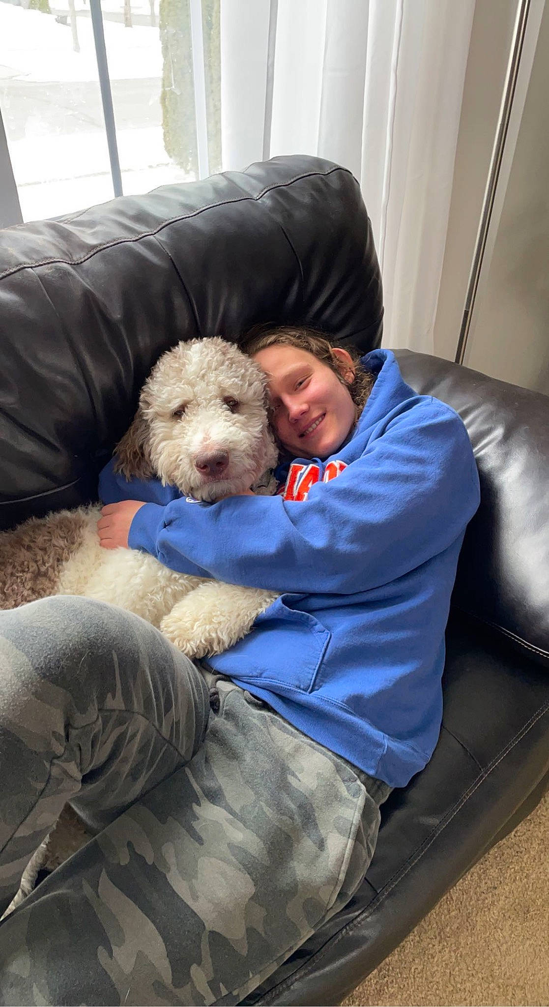 Kody joined the competition — help win amazing prizes! canidae, carnivore, chair, child, comfort, companion_dog, couch, curtain, dog, dog_breed, dog_supply, fur, labradoodle, lap, sitting, smile, sporting_group, toy, toy_dog, working_animal