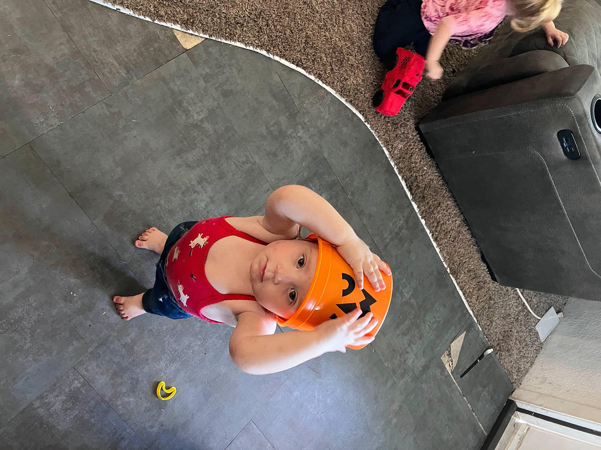 Aurora is registered to the contest to win money with this photo: asphalt, baby, baby_carriage, baby_products, baggage, child, costume, flooring, fun, headwear, human_leg, leisure, luggage_and_bags, person, personal_protective_equipment, recreation, sidewalk, sitting, suitcase, thigh