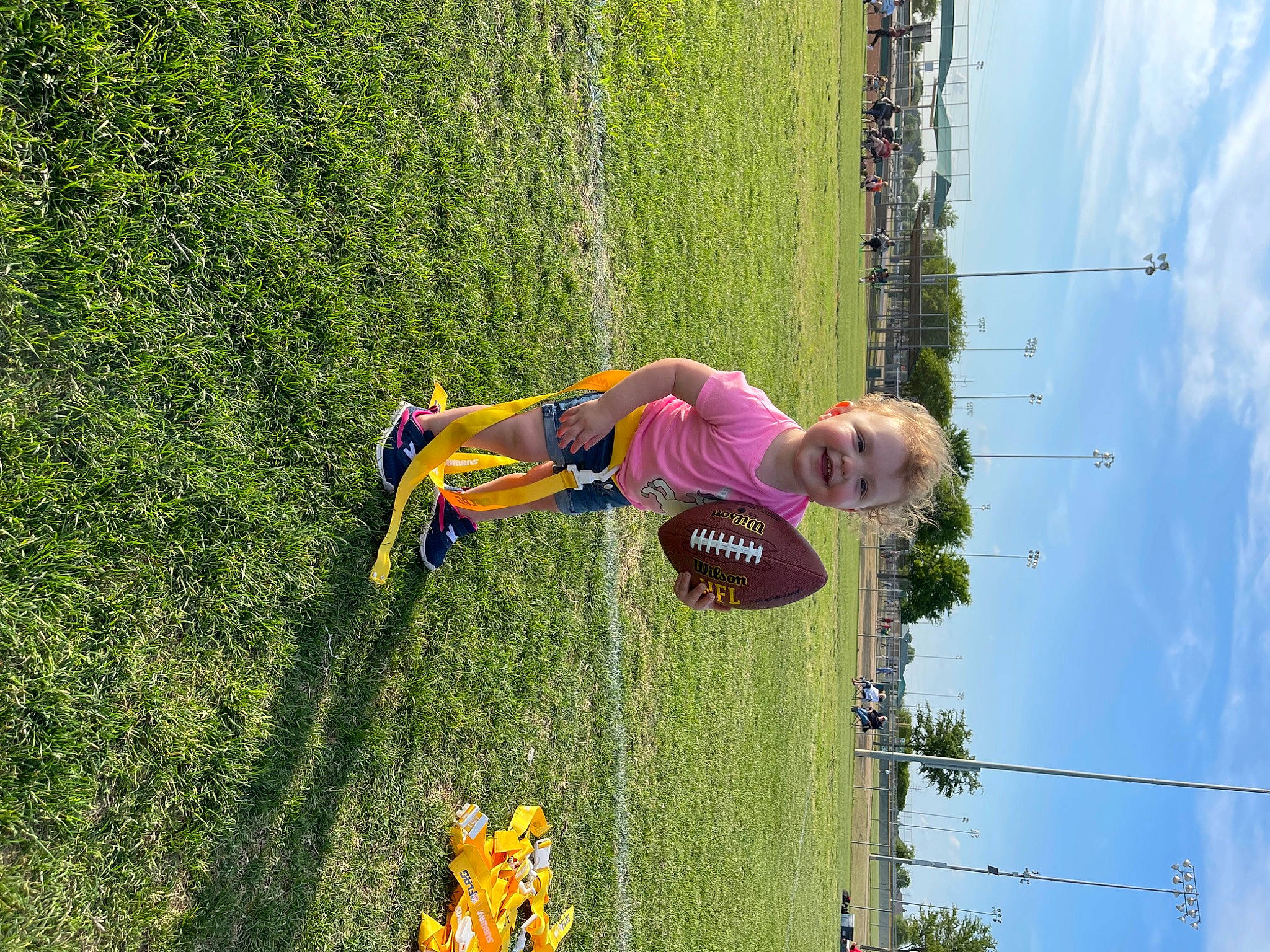 Lilyann is registered to the contest to win money with this photo: adventure, cloud, fun, grass, grass_family, grassland, green, happy, joy, landscape, lawn, leisure, people_in_nature, person, plant, recreation, shrub, sky, tire, toddler