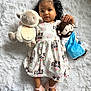 Ayla is registered to the contest to win money with this photo: toddler, child, plush_toy, stuffed_animal, dress, floral_pattern, sandals, bow, curly_hair, indoor, white_background, soft_texture, cute, peaceful, lying_down, baby, face, person, smiling, holding