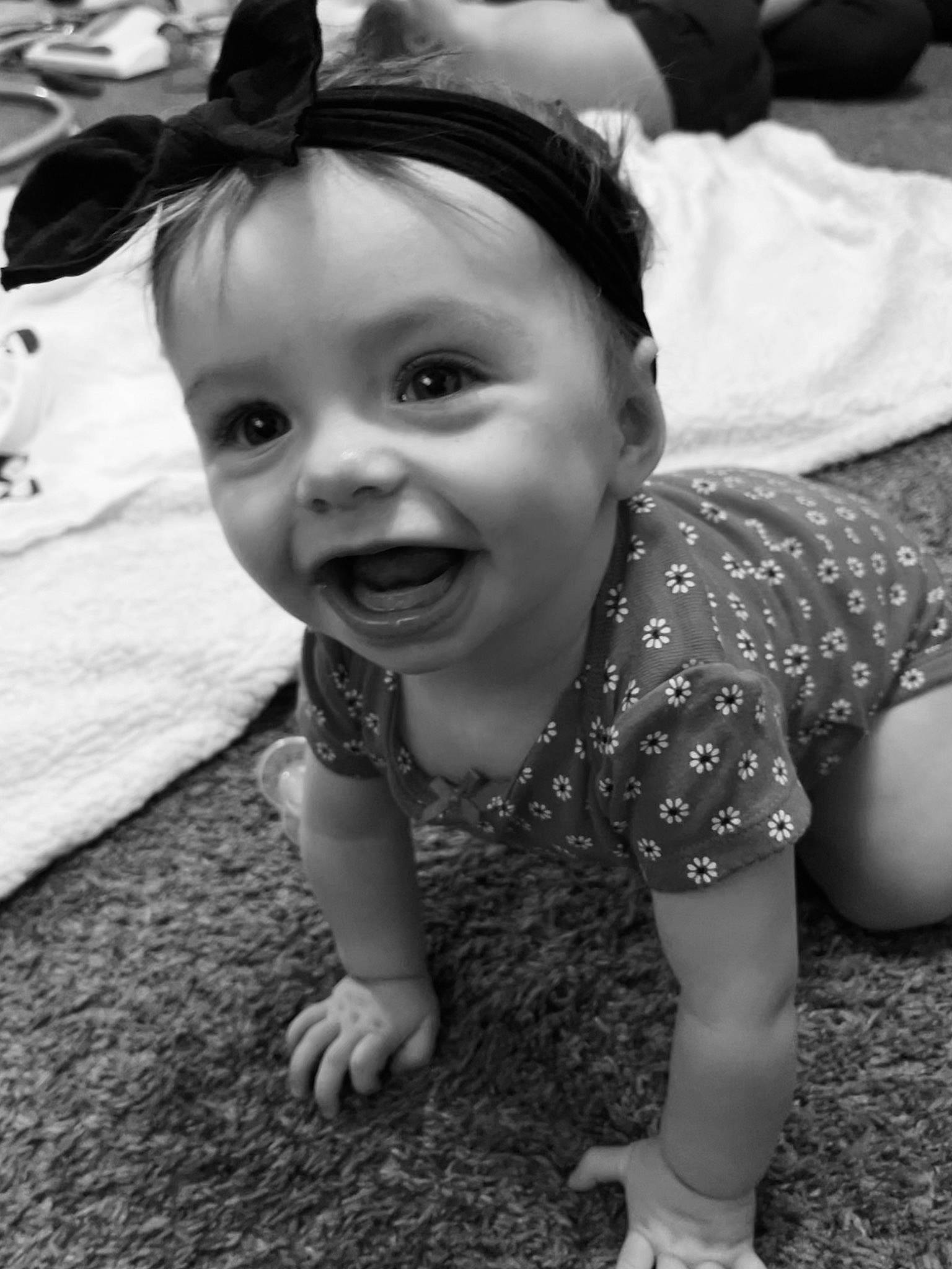 Mariana is registered to the contest to win money with this photo: baby, baby_toddler_clothing, black_and_white, child, eye, flash_photography, fun, grass, happy, head, iris, monochrome, monochrome_photography, person, sitting, skin, smile, standing, style, toddler