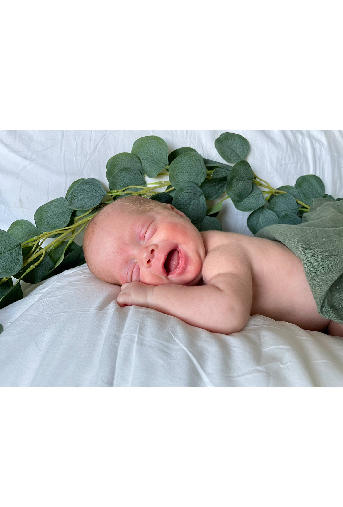 Lance is registered to the contest to win money with this photo: baby, bedding, comfort, face, fashion_accessory, flesh, fur, grass, happy, linens, natural_material, pattern, peach, person, petal, portrait_photography, rose_family, rose_order, sitting, toddler