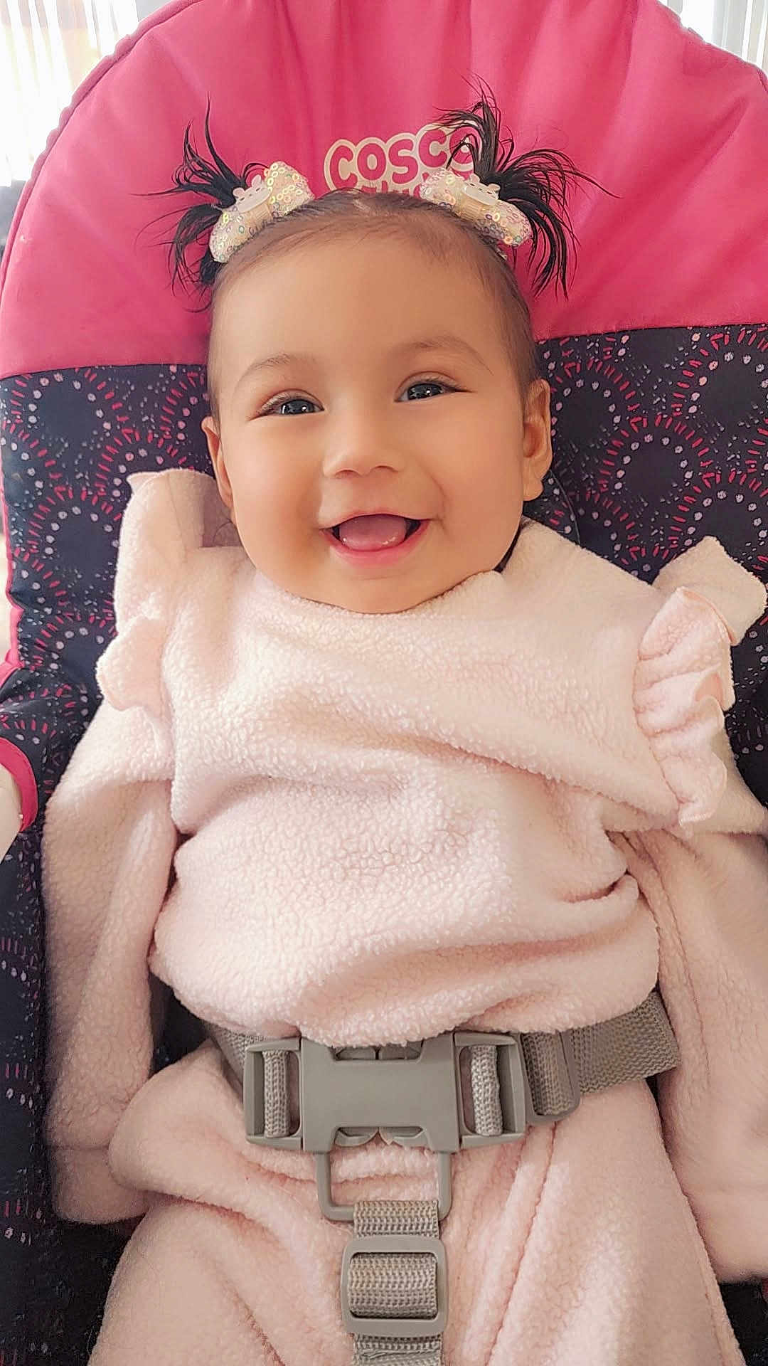 Avery Mae Zuniga is registered to the contest to win money with this photo: baby, child, smiling, pigtails, bows, pink_clothing, car_seat, safety_belt, cute, happy, infant, face, portrait, indoors, soft_texture, child_seat, young_child, adorable, warm_clothing, closeup