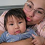 Avery Mae Zuniga joined the competition — help win amazing prizes! baby, child, adult, glasses, nose_ring, hug, indoor, portrait, person, face, affection, love, casual_clothing, head, skin, hand, hair, comfort, family, closeup