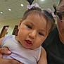 Avery Mae Zuniga is registered to the contest to win money with this photo: toddler, child, baby, girl, pigtails, hair_bows, purple_clothing, indoor, ceiling_lights, hallway, adult_hand, holding, closeup, face, expression, casual_clothing, person, portrait, cute, young_child