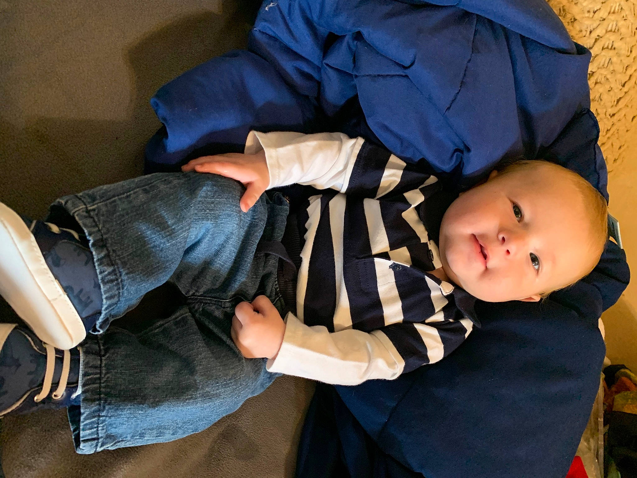 Ezra is registered to the contest to win money with this photo: baby, baby_products, baby_toddler_clothing, child, comfort, denim, elbow, flash_photography, fun, human_body, human_leg, knee, lap, pattern, person, room, sitting, thigh, toddler, tree