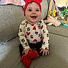 baby, child, red_bow, onesie, numbers, hearts, smiling, couch, blanket, toy, mirror, reflection, indoor, happy, sitting, cute, clothing, infant, playful, cozy