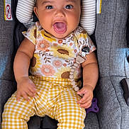 Kensie is registered to the contest to win money with this photo: baby, child, smiling, happy, car_seat, headband, yellow_pants, floral_top, socks, infant, cute, indoors, seat_belt, clothing, person, portrait, young_child, baby_accessory, fabric, seat