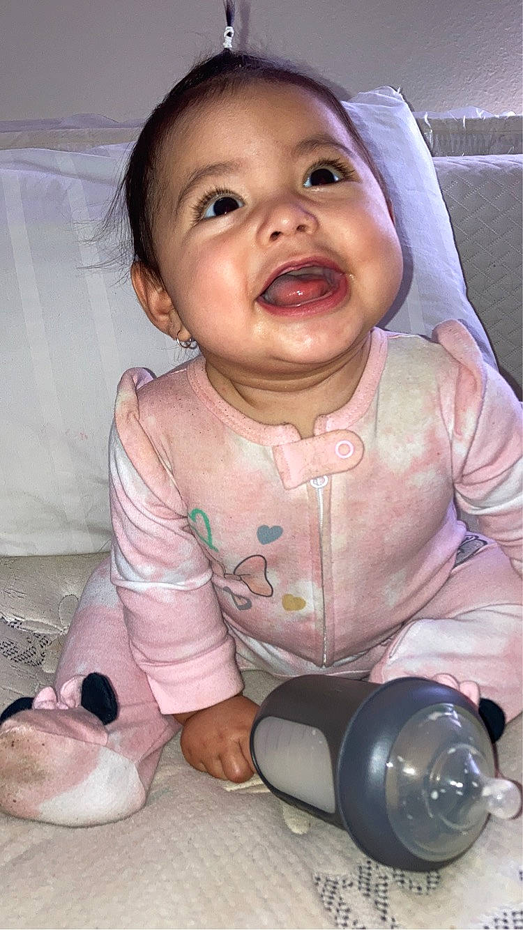 Ezlynn is registered to the contest to win money with this photo: arm, baby, baby_toddler_clothing, cheek, child, finger, fun, gesture, hand, happy, iris, lip, mouth, nose, person, pink, skin, smile, thumb, toddler