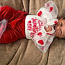 baby, blanket, celebration, child, cozy, cute, fabric, festive, happy, hearts, holiday, infant, lying_down, portrait, red_clothing, smiling, toddler, tulle, valentines_day, white_clothing